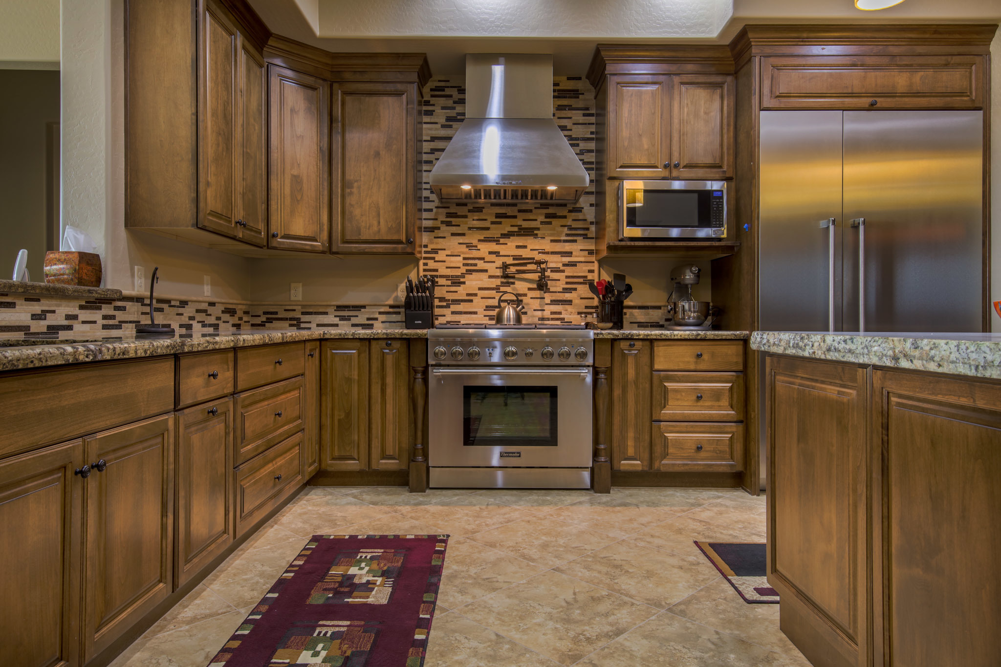 Sollid cabinetry installation in Phoenix kitchen with crown moulding and custom finish by Maverick Kitchens